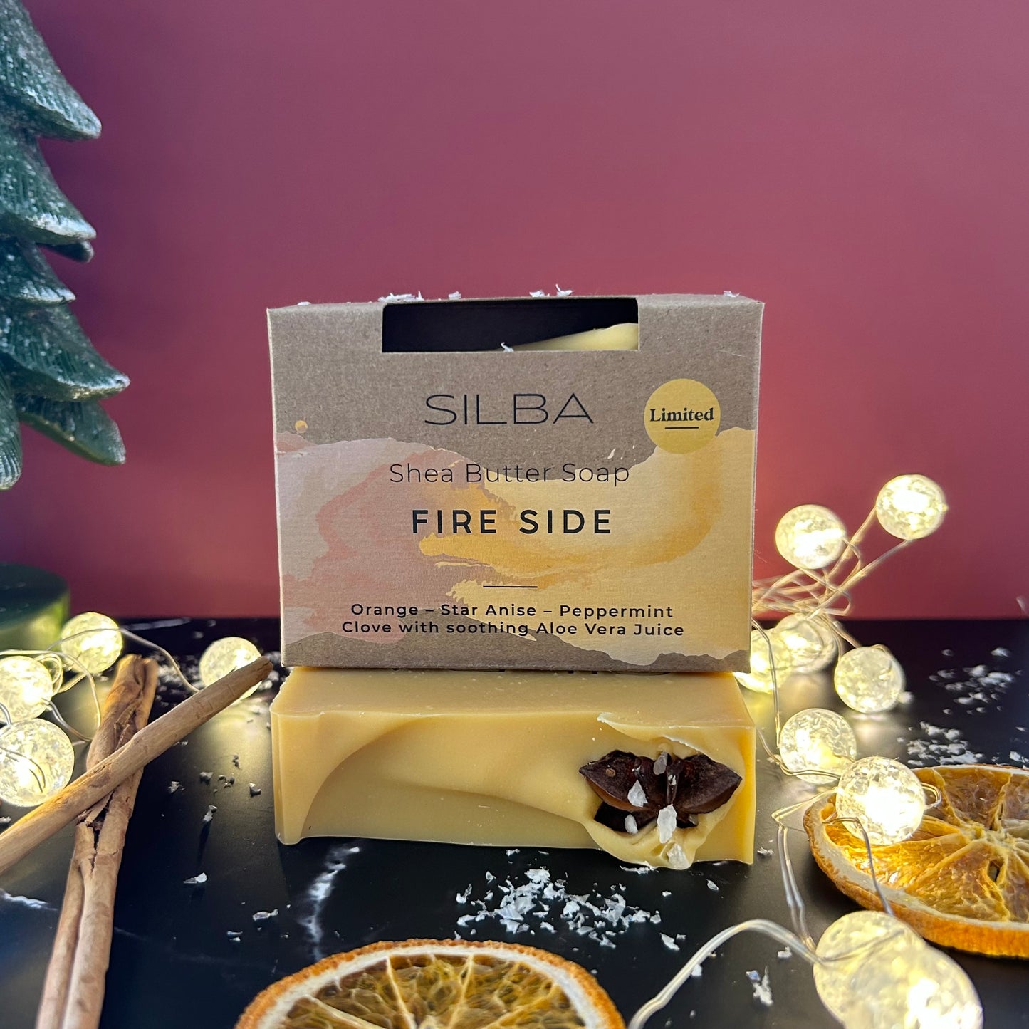 Winter Collection Shea butter soap bar with 'SILBA' packaging on a decorative surface with lights and oranges.