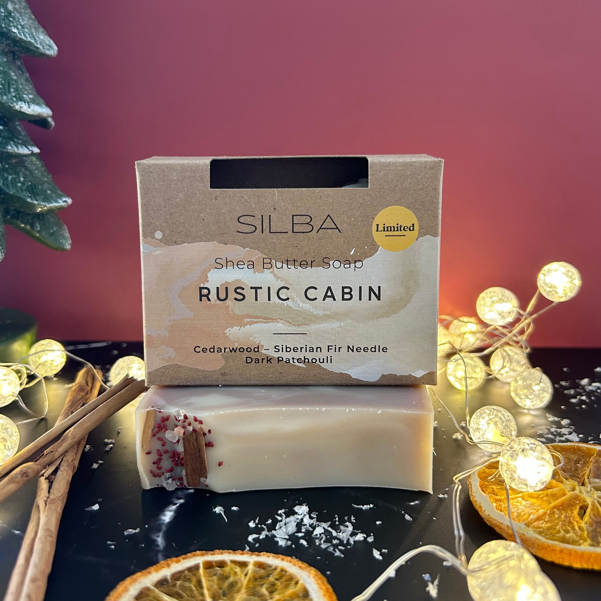 SILBA Rustic Cabin soap with packaging on a decorative surface with lights and cinnamon sticks.